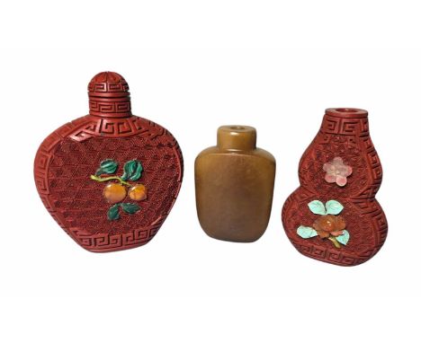 Three Chinese Snuff Bottles.  To include Two carved Cinnabar lacquer snuff bottles with applied Gemstones in the form of frui