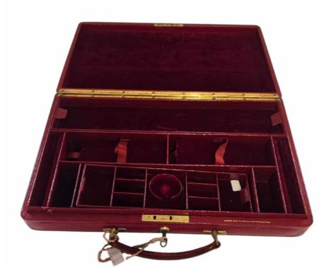 A lockable red leather Jewellery storage briefcase. with key. red velvet sectioned interior. 39cm x 23.5cm x 6cm. In good con