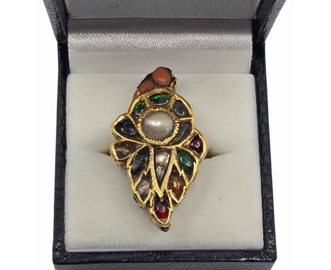 An enamelled and gem set Mughal ring. Coral, Jade Pearl and Glass. The ring tests as 22ct gold. The front of the ring set wit