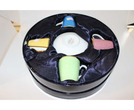 A Royal Worcester harlequin set of four coffee cups and saucers, printed marks "Royal Worcester in celebration of HRH 80th bi