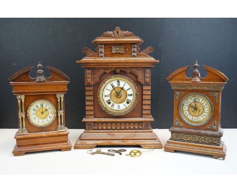 Ansonia Clock Co parlour clock in wooden case and carved detail together with two wooden cased mantle clocks with gilt detail