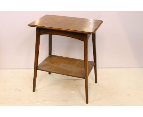 Early 20th Century oak two tier side table having a canted rectangular top raised on angular block legs with shelf below. Mea