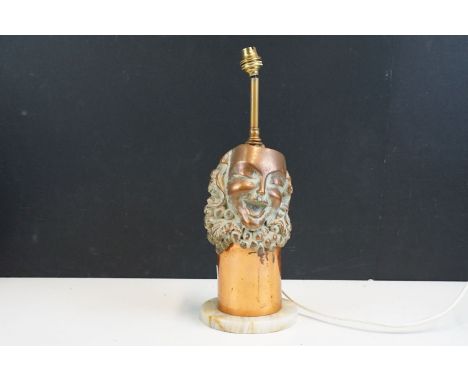 Laughing theatre mask with fruit background surround detail copper table lamp base on stone stand, H 43cm