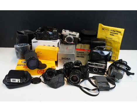 Quantity of cameras to include Canon A-1 fitted with 35mm zoom lens, together with kodak, sigma, canon point and shoot, Ricoh