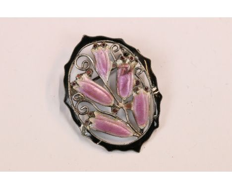 Art Nouveau silver and enamel oval brooch with pink bell flower design within a black enamel border, 3.3cm long