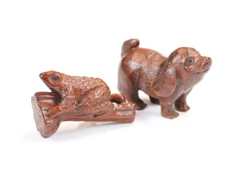 Two carved wooden netsuke figures to include dog and a frog on stick 