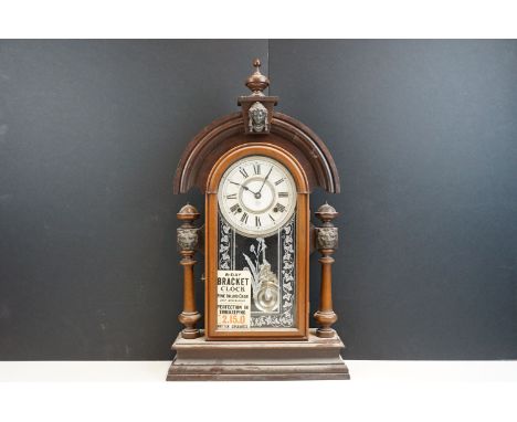 Early 20th century Ansonia mantle clock with wooden case, carved lions head columns and portrait decoration with etched glass