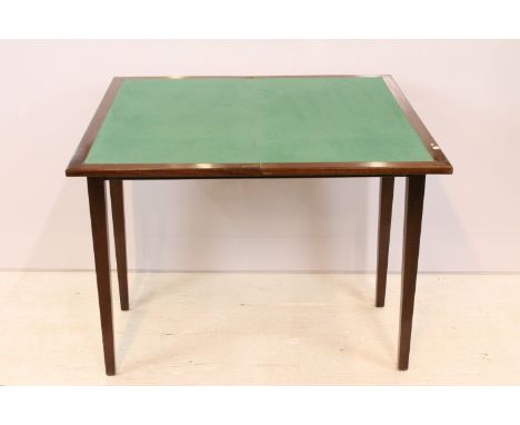 Early 20th Century mahogany card table having a fold over top with green felt lined interior raised on tapering block legs. M