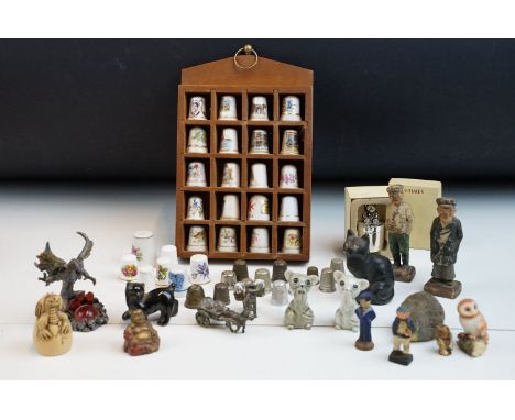 Souvenir ceramic thimbles together with metal examples and wall display shelf along with an assortment of various figurines t