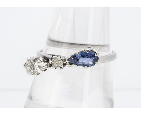 An unusual sapphire and diamond dress ring, the three stones comprising a diamond and sapphire pear cut either side of a cent