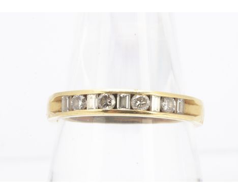 An 18ct gold diamond half hoop eternity ring, with alternating brilliant cuts and baguettes into the channel setting, ring si