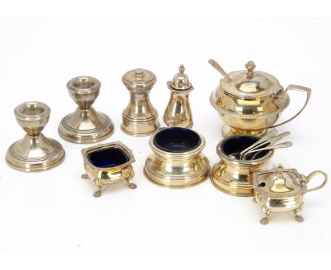 A collection of Art Deco and later silver cruet items, including a large mustard, a pair of trench salts, a three piece set o