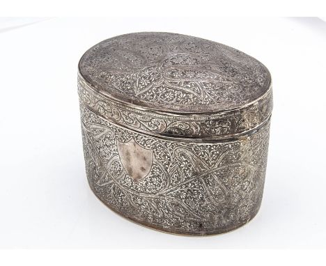 A second half 19th Century Middle Eastern white metal tea caddy, oval with an intricate scrolling design and having vacant sh