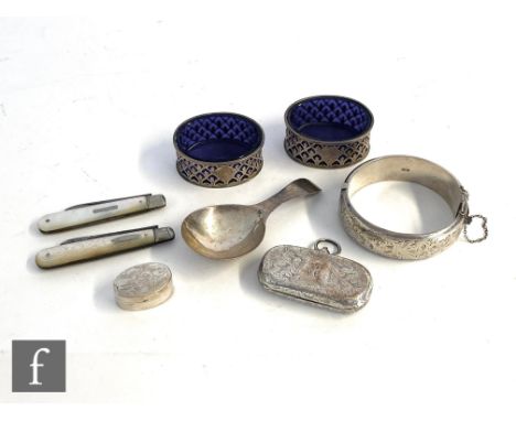 A small parcel lot of assorted hallmarked silver items to include a Georgian caddy spoon, a pair of open salts, two mother of