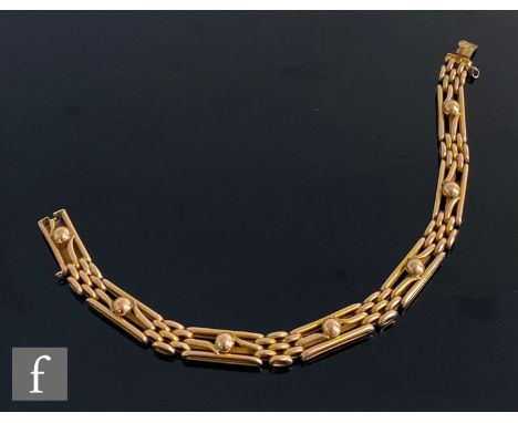 An early 20th Century 9ct rose gold three bar gate bracelet with shot details terminating in tongue and box fastener, weight 