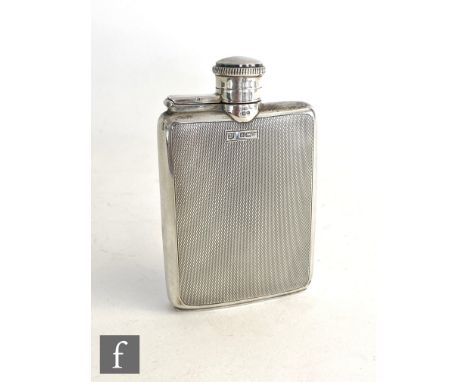 A hallmarked silver small hip flask with engine turned decoration to whole and terminating in hinged screw cap, weight 80g, h