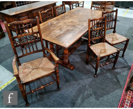 A 17th Century style oak refectory dining table on twin pillar supports united by a central stretcher, height 76cm x depth 87