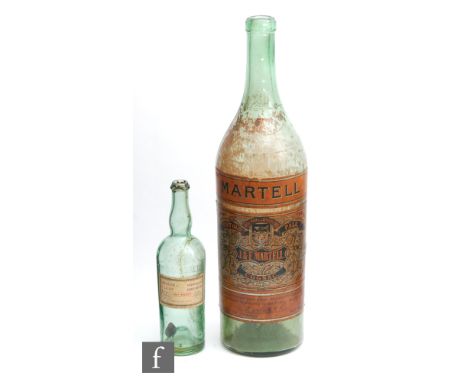 A giant early 20th Century Martell Cognac advertising bottle decorated with applied printed labels, height 58cm, together wit