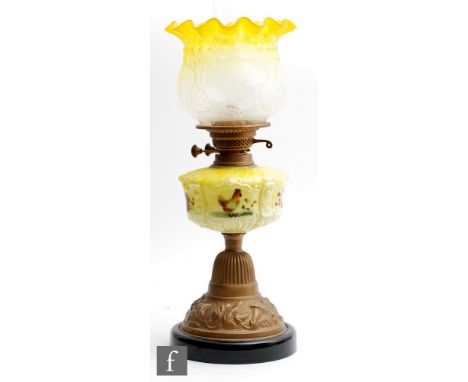 A late 19th Century oil lamp, the stepped gilt metal base relief moulded with convolvulus flowers and foliage beneath and gra
