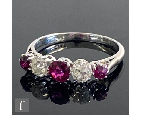 A platinum graduated ruby and diamond five stone ring, two old cut diamonds each approximately 0.33ct spaced by rubies, all s