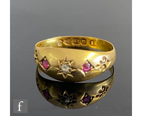 A 19th Century 18ct hallmarked gypsy set ruby and diamond three stone ring with fleur de lys detail to shoulders, weight 1.8g