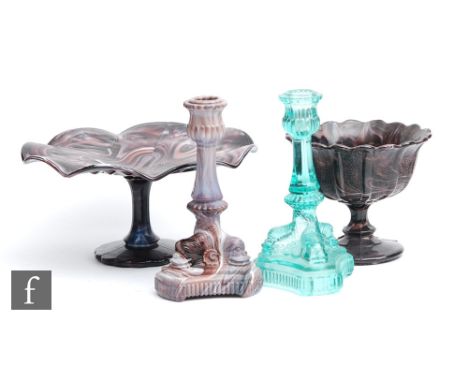 A late 19th Century purple malachite pressed glass candlestick formed as three dolphin heads forming the pedestal, unmarked b