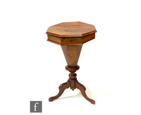 A Victorian walnut work or sewing table of tapered octagonal form, the hinged top enclosing a fitted interior above a turned 