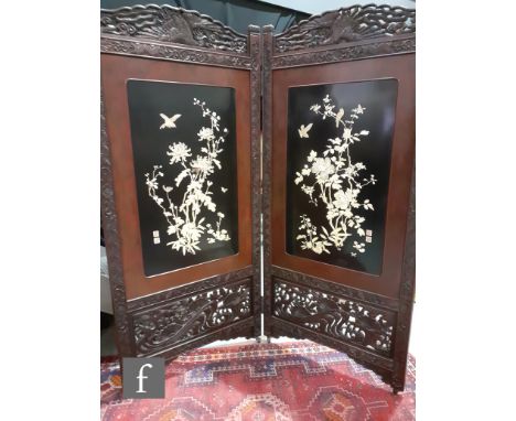 A late 19th Century Japanese two fold lacquered screen, each panel decorated with mother of pearl and ivory flowering boughs,