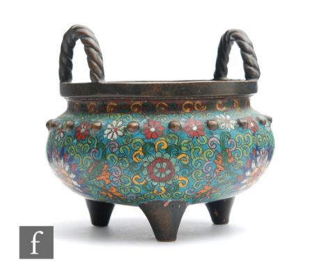 A Chinese cloisonne censer of typical bombe form, raised on three tripod supports, the exterior body decorated with lotus spr