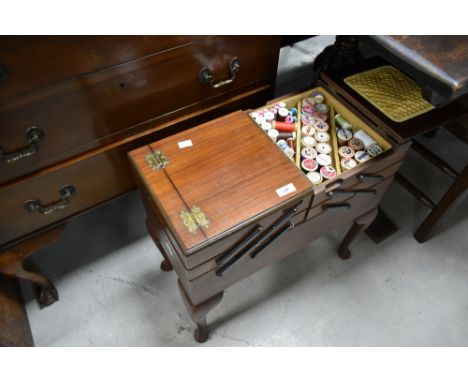 A vintage cantilever sewing box, and contents including cotton reels