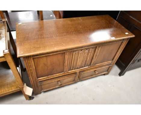 A vintage oak bedding chest having linen fold decoration to front panel, width approx. 99cm