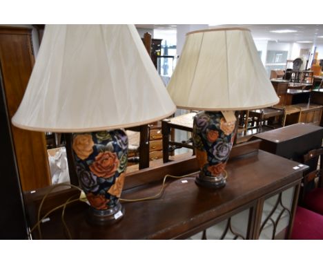 A pair of vintage style table lamps having tube lined style foliate decoration