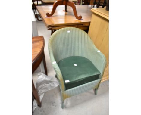 A vintage Lloyd Loom tub chair having upholstered seat
