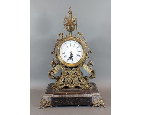 A French brass mantle clock, the enamel dial with Roman and Arabic numerals upon a marble and slate base, 43cms tall 