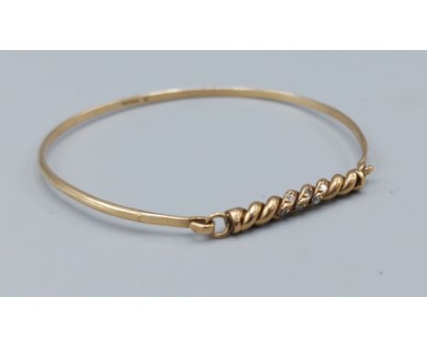 A 9ct gold bangle set with two rows of diamonds, 5.2gms 