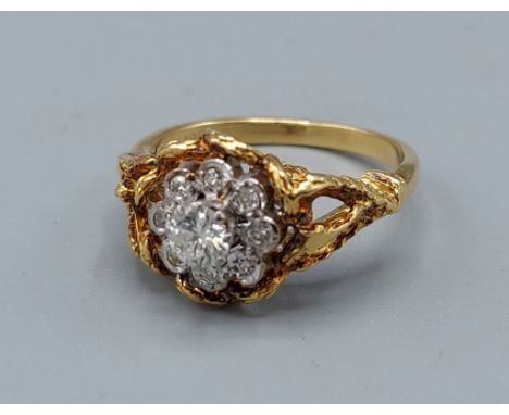 An 18ct gold diamond cluster ring, set with a central diamond surrounded by diamonds, 4.2gms, ring size K 