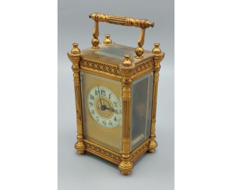 French brass cased carriage clock the enamelled chapter ring with Roman numerals, 13cm high 