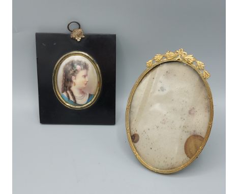A 19th Century oval portrait miniature painted on glass with ebonised frame, together with gilt metal oval picture frame 