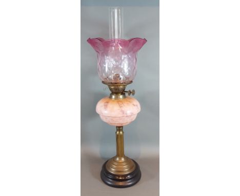 A Victorian Brass and glass oil lamp with opalescent glass bowl and cranberry glass shade, 54cm high 