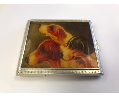 A hallmarked silver cigarette case with a scene depicting three fox hounds. 