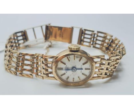 A vintage ladies Rotary 9ct gold wristwatch with gold gate bracelet strap and security chain. 16.4g Strap 16.5 cm - 18 cm adj
