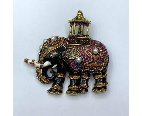 A large, enamel and gems, brooch depicting an Indian ceremonial Elephant, together with a pair of earrings, in a presentation