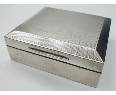 Vintage silver cigarette box. Compact size with engine turned design to lid. Plywood lined, 9.7x8.7cm approx Clear hallmark f