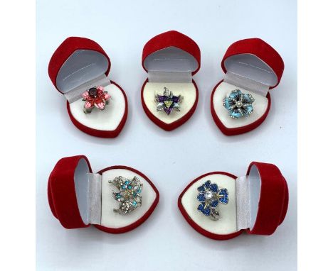 Five silver (stamped ?925?) floral rings with enamel and gems in heart shaped red velvet presentation boxes. 