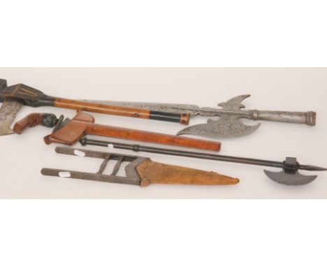 A Kris with wooden scabbard and decorated blade, together with a small steel replica axe, a Malaysian axe with hatched head a