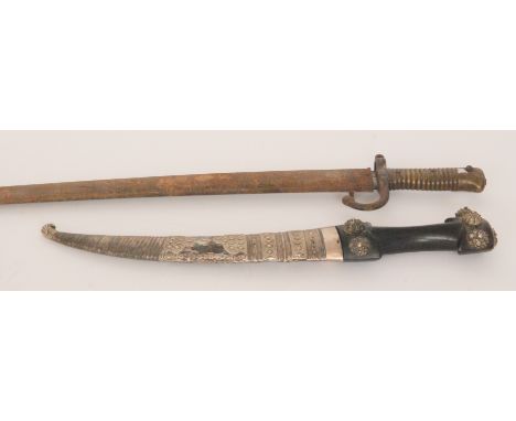 An Indian dagger the shaped ebony handle mounted with bead foliate bosses, 25cm blade in embossed white metal scabbard togeth