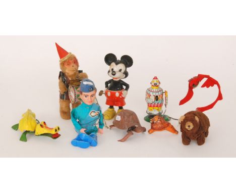 A 1960s clockwork tinplate lion tamer clown together with a clockwork crocodile, a tortoise, a Mickey Mouse, a felt covered w