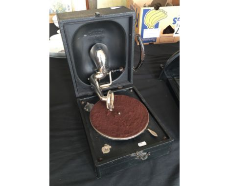 A black cased Decco Junior Portable record player with records.