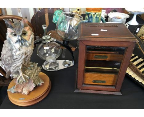 An oak glazed smokers cabinet, Cona coffee maker with stand and a model of an owl.