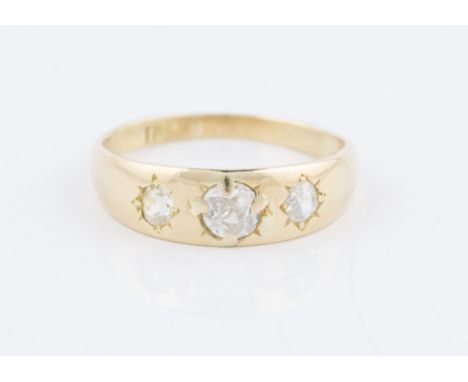 An 18ct yellow gold three stone diamond ring, star set with three graduated old cut diamonds, stamped 18ct, ring size K, weig